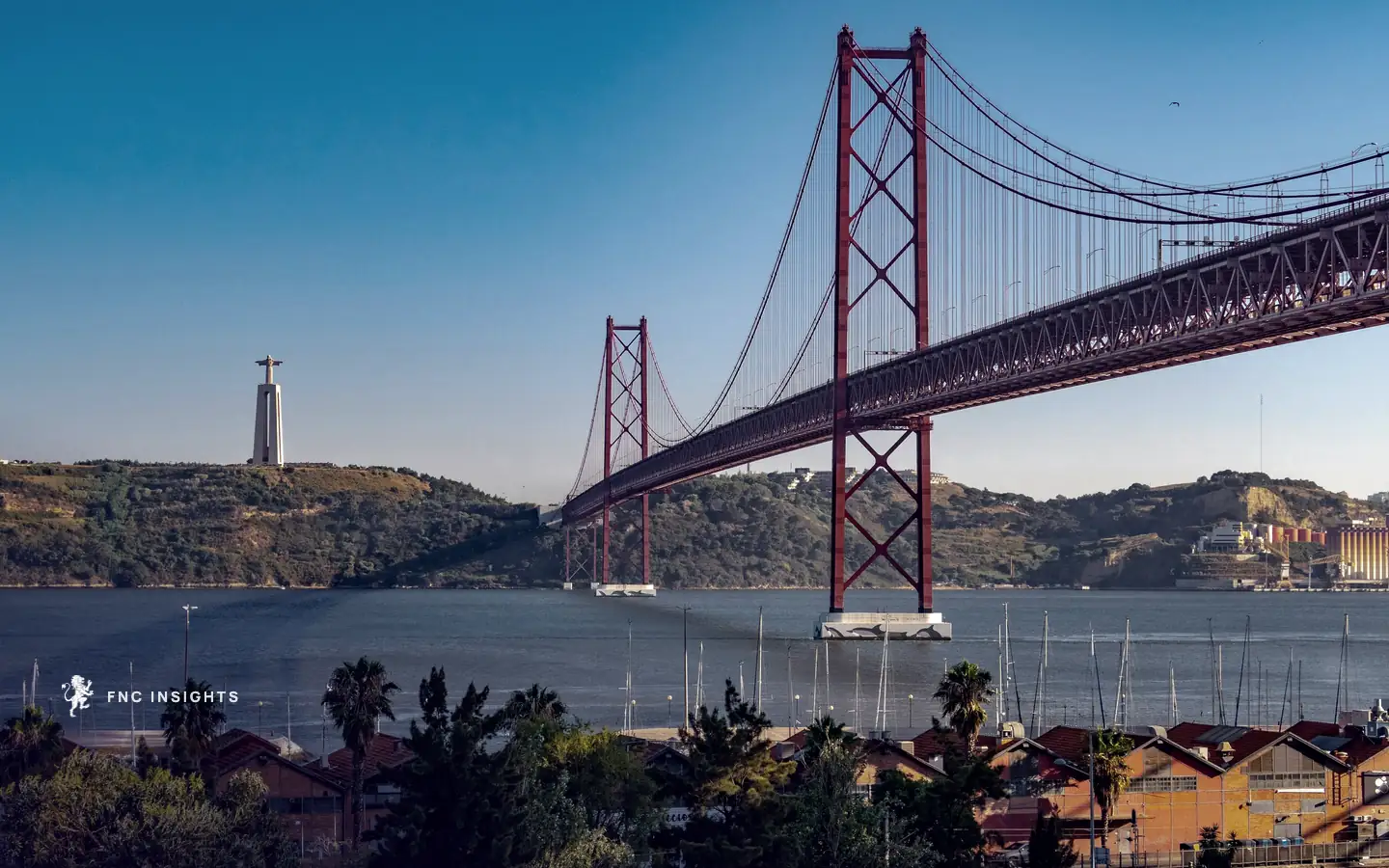 The 25 de Abril Bridge across the Tagus in Lisbon, with the Cristo Rei statue on the far bank