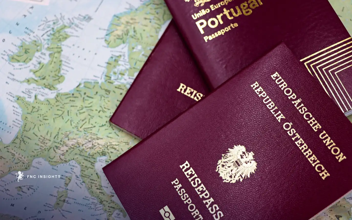 Austrian and Portuguese passports lying on a map of Europe