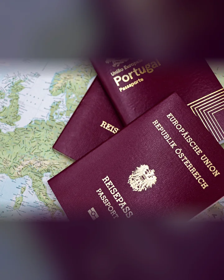 Austrian and Portuguese passports lying on a map of Europe